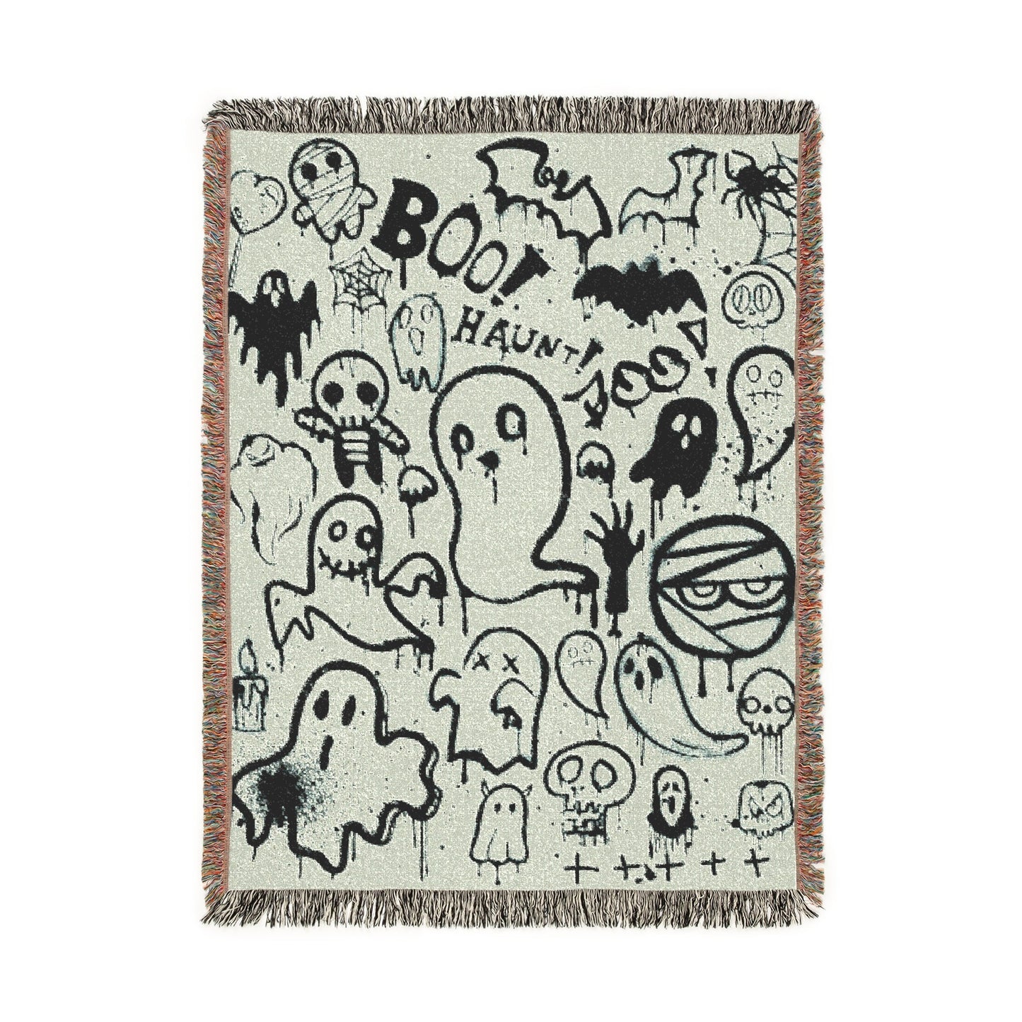 Woven blanket with Halloween-themed designs on a white background