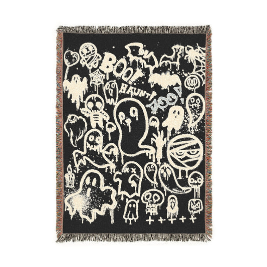 Decorative throw blanket with Halloween-themed design on a black background
